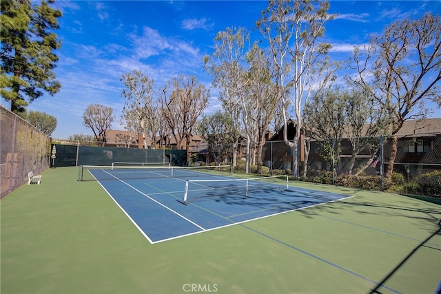 view of sport court featuring fence