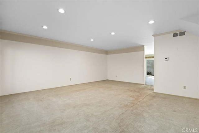 unfurnished room featuring recessed lighting, visible vents, crown molding, and light colored carpet