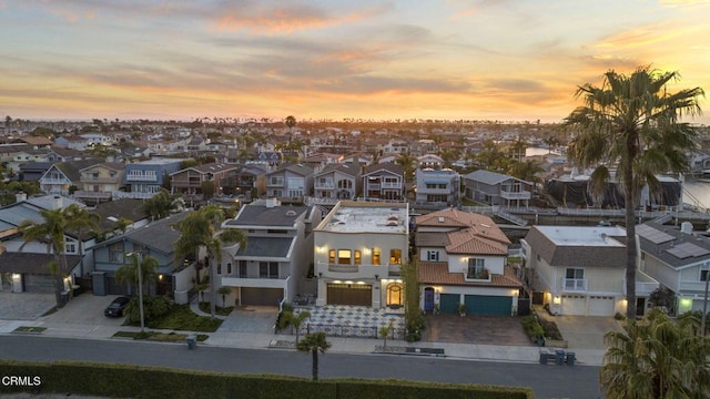 aerial view at dusk featuring a residential view