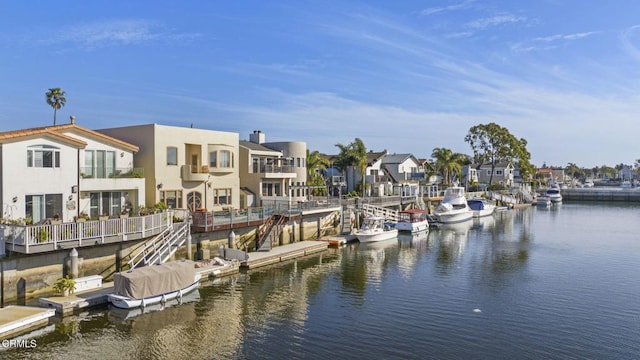 dock area featuring a residential view and a water view