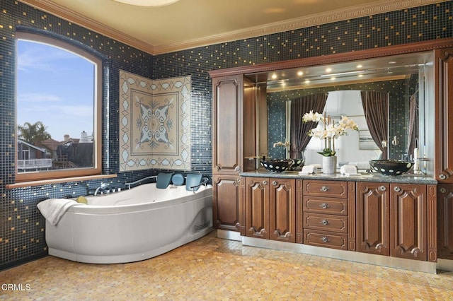 bathroom featuring double vanity, crown molding, and a bath