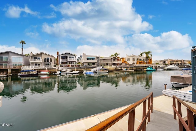 dock area featuring a water view and a residential view