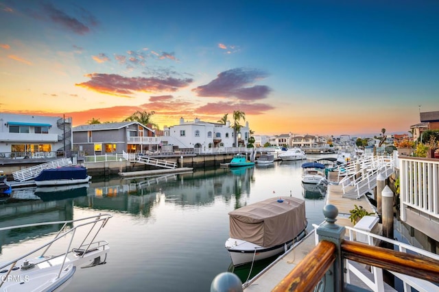 dock area featuring a water view and a residential view