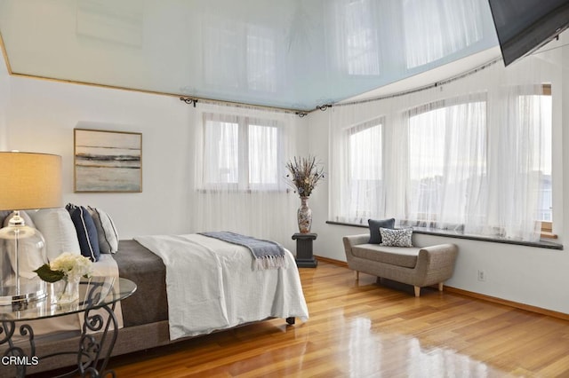 bedroom featuring baseboards and wood finished floors