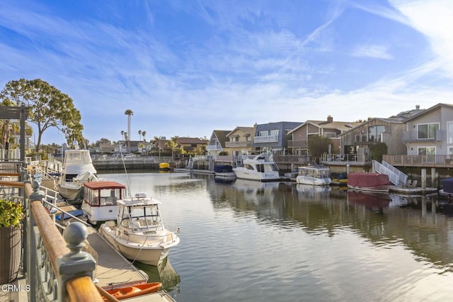 property view of water with a boat dock and a residential view