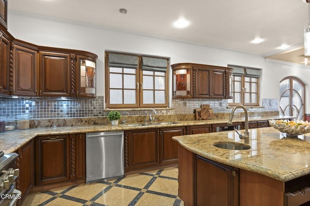 kitchen with tasteful backsplash, appliances with stainless steel finishes, and a sink