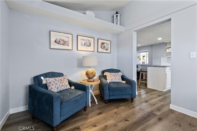 living area featuring baseboards, wood finished floors, and recessed lighting