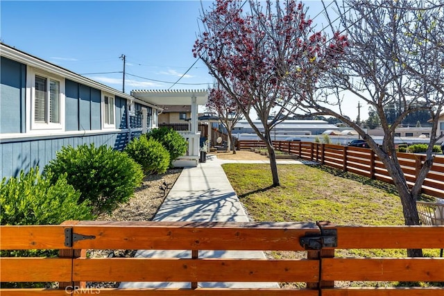 view of yard featuring fence and a pergola