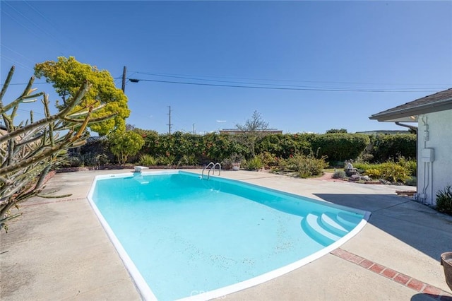 view of swimming pool with a fenced in pool and a patio area