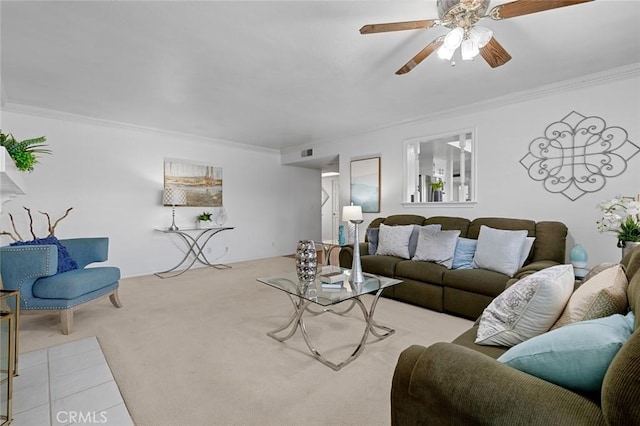 living area featuring ornamental molding, carpet, visible vents, and a ceiling fan