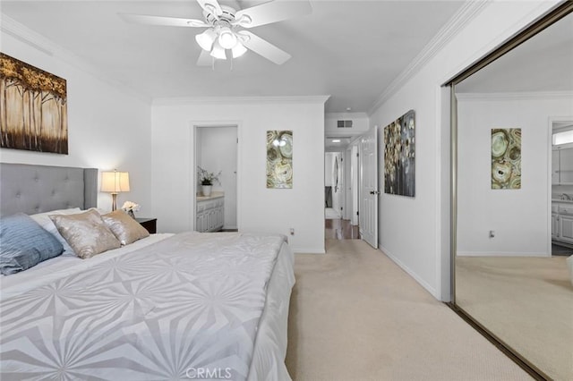 bedroom featuring light carpet, ornamental molding, and connected bathroom