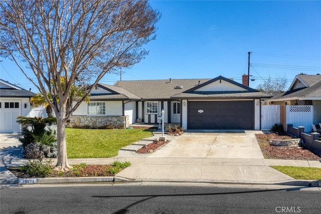 single story home with stucco siding, concrete driveway, a front yard, fence, and a garage