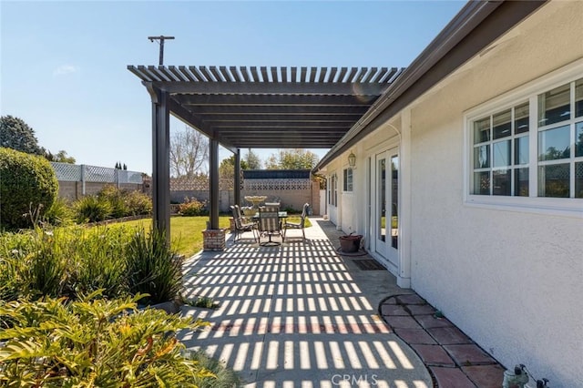 view of patio featuring outdoor dining area, fence, and a pergola