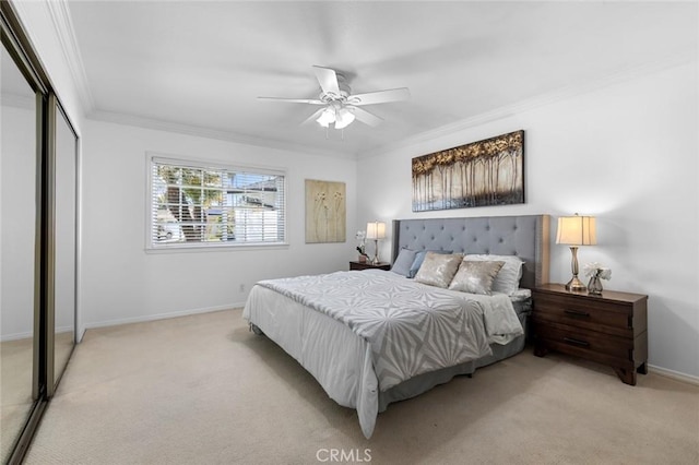 bedroom with crown molding, a closet, light carpet, ceiling fan, and baseboards