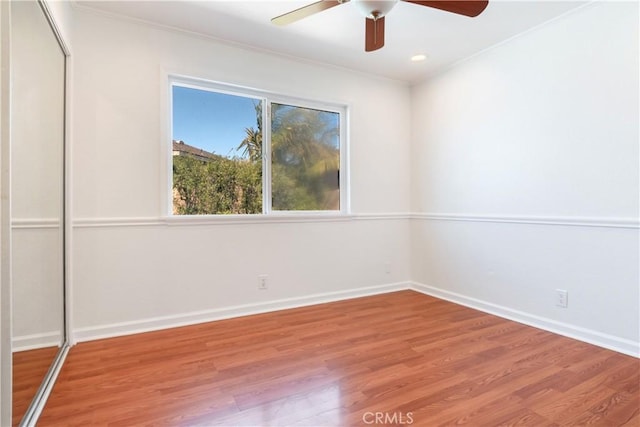 spare room featuring ceiling fan, recessed lighting, wood finished floors, baseboards, and ornamental molding