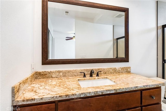 bathroom featuring visible vents, a ceiling fan, and vanity