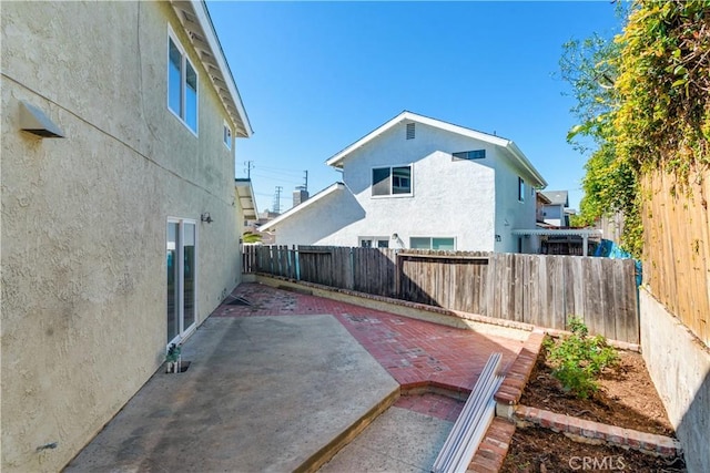 exterior space with a patio area and a fenced backyard