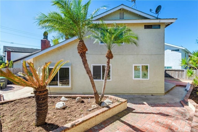 view of home's exterior featuring a patio area, fence, and stucco siding