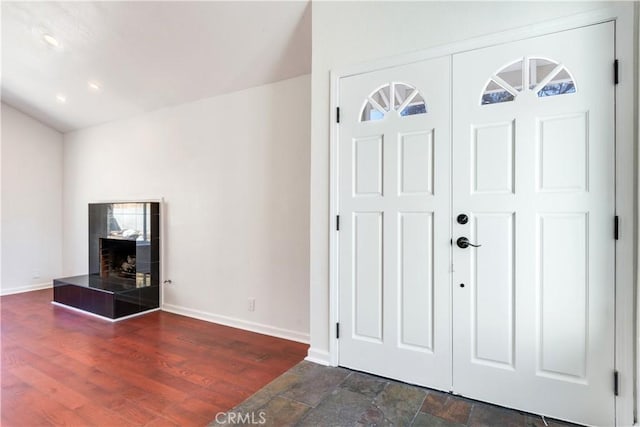 entryway featuring baseboards and wood finished floors