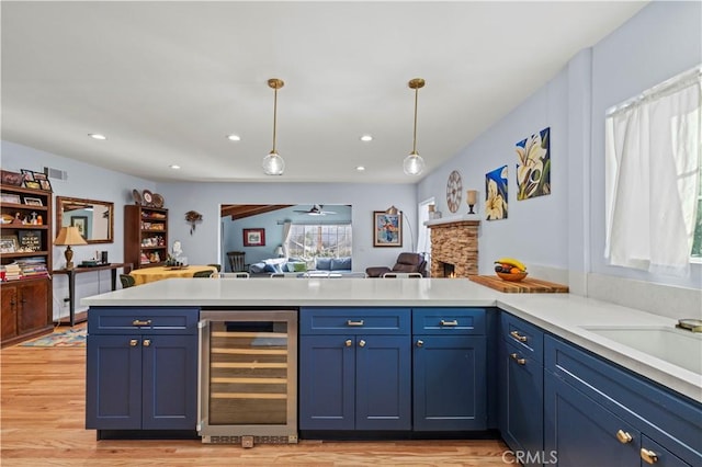 3104 Altura Ave, La Crescenta, CA 91214 - kitchen with wine cooler, light countertops, open floor plan, blue cabinetry, and a peninsula