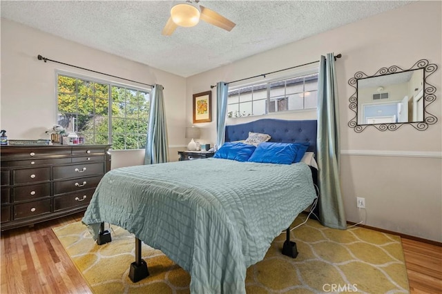 3104 Altura Ave, La Crescenta, CA 91214 - bedroom featuring wood finished floors, a textured ceiling, multiple windows, and a ceiling fan