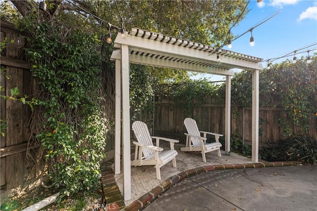 view of patio / terrace featuring fence and a pergola