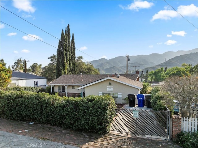3104 Altura Ave, La Crescenta, CA 91214 - view of side of home with a mountain view, stucco siding, and a gate