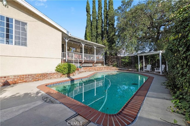 view of swimming pool featuring a fenced in pool, fence private yard, and a patio area