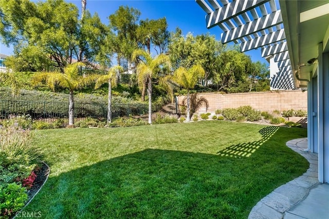 view of yard featuring fence and a pergola