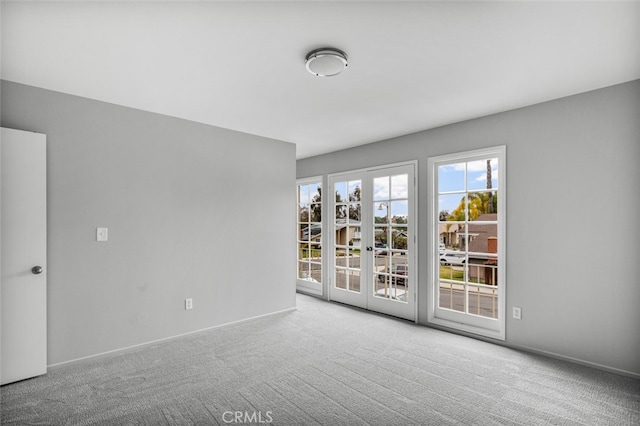 unfurnished room with carpet and baseboards