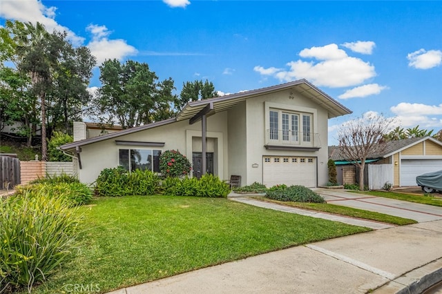 view of front of property featuring stucco siding, a front lawn, fence, concrete driveway, and a garage