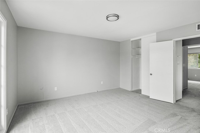 unfurnished bedroom featuring a closet, visible vents, and carpet floors