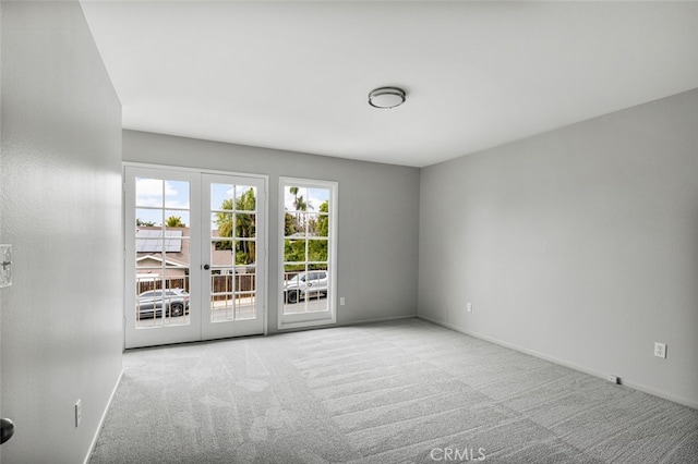 empty room featuring carpet and baseboards