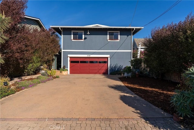 view of front of property featuring concrete driveway and an attached garage