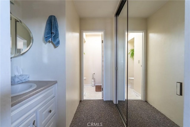 bathroom featuring toilet and vanity