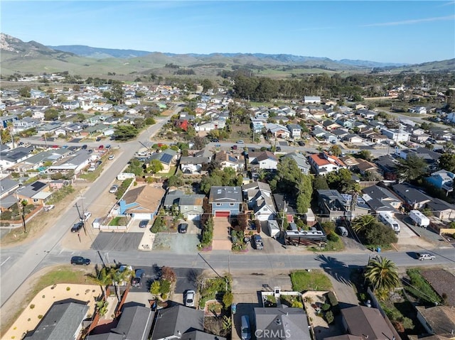 drone / aerial view featuring a residential view and a mountain view