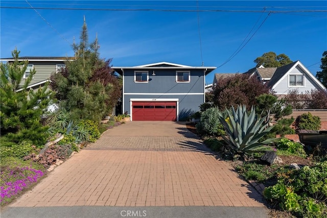 view of front of home featuring decorative driveway and an attached garage