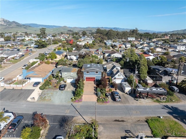 drone / aerial view featuring a residential view and a mountain view