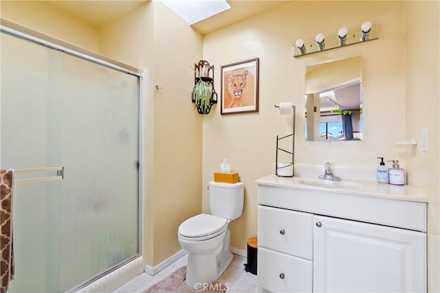 full bathroom with a skylight, toilet, a shower stall, vanity, and baseboards