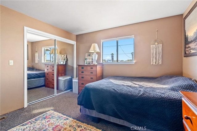 bedroom with carpet and a closet