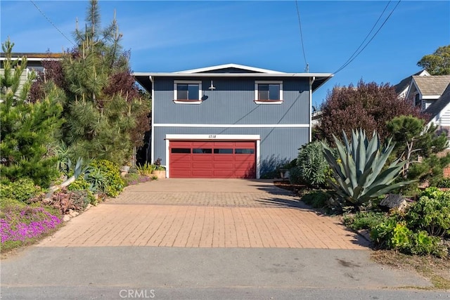 view of front facade featuring a garage and decorative driveway