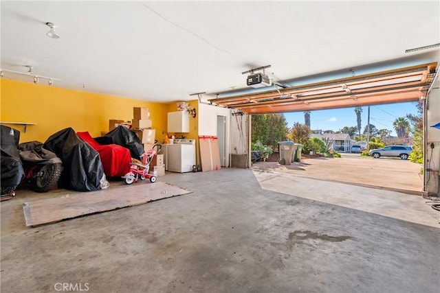 garage with washer / dryer and a garage door opener