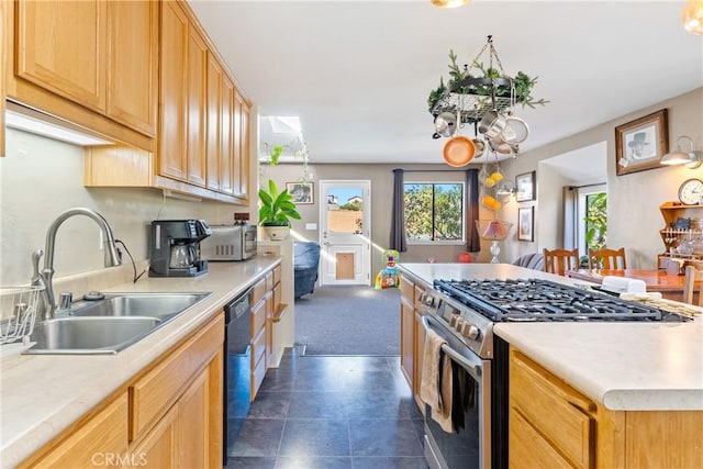 kitchen featuring a center island, stainless steel appliances, a sink, and light countertops