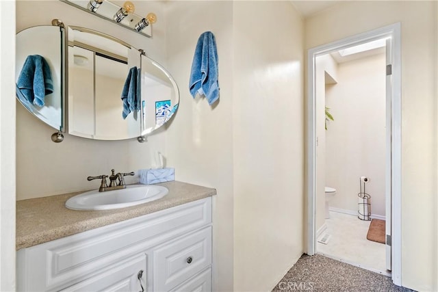 bathroom featuring toilet and vanity