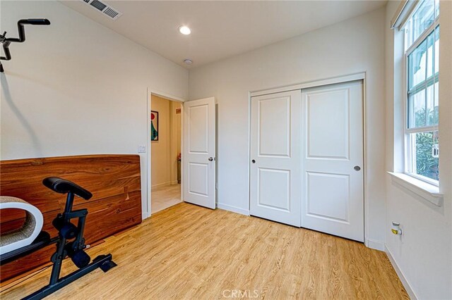 interior space featuring recessed lighting, baseboards, visible vents, and light wood finished floors