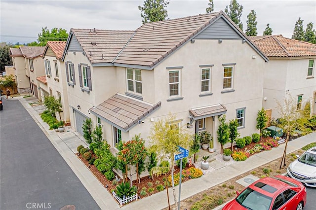 exterior space featuring stucco siding and a tiled roof