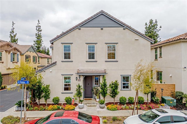 view of front of home with a tile roof and stucco siding