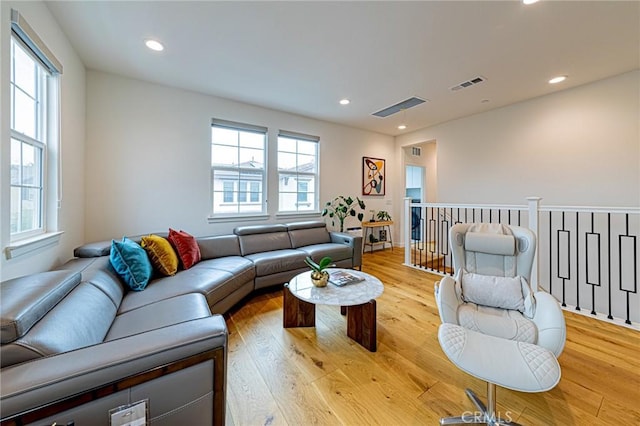 living room with recessed lighting, visible vents, and light wood-style flooring