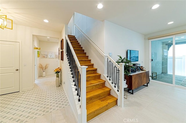 stairs with tile patterned floors and recessed lighting