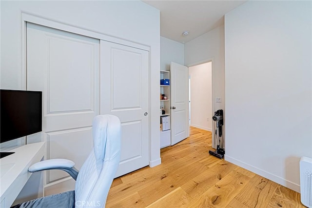 home office featuring light wood finished floors and baseboards